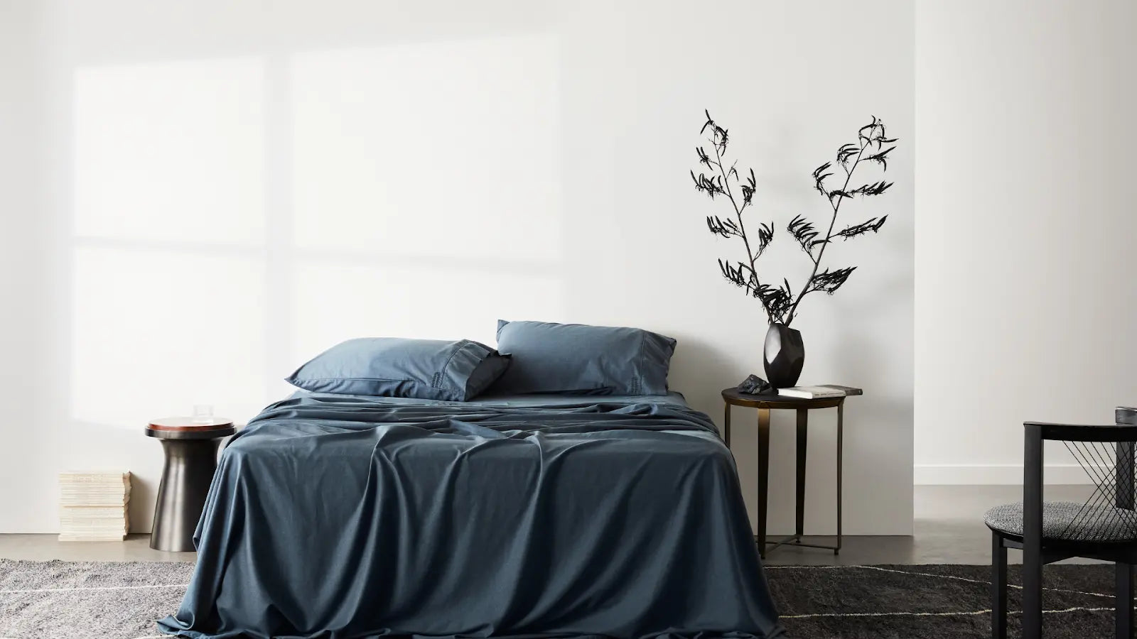 A Set of Blue ettitude Sheets On A Bed