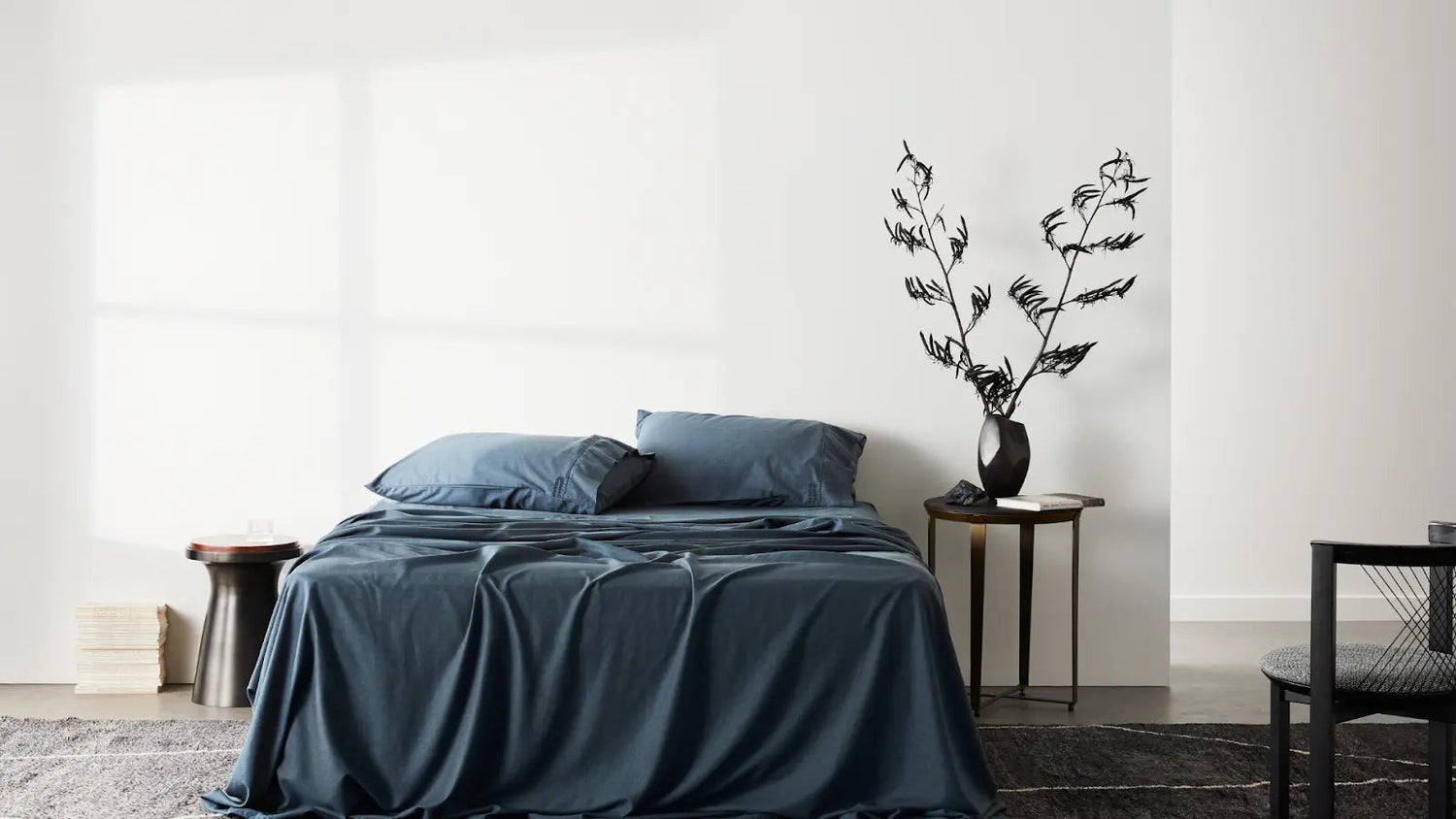 A Set of Blue ettitude Sheets On A Bed