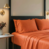 Papaya pillowcases bring a vibrant, sun-warmed accent to clean, modern bedding