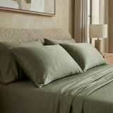 Modern bedroom with silky-soft sateen sheets in muted fern green for a calm, earthy vibe.